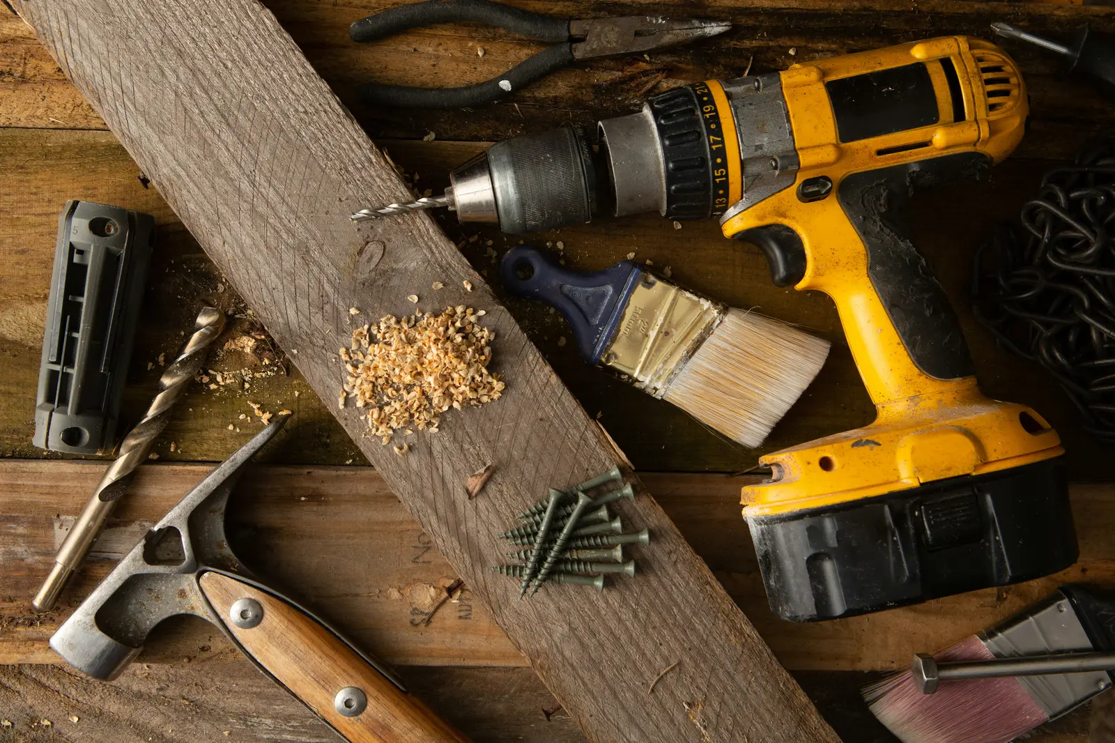 Drill, hand tools, and sawdust on a guitar builder's workbench — the small-scale shop setup at the center of Fender's cease-and-desist letters