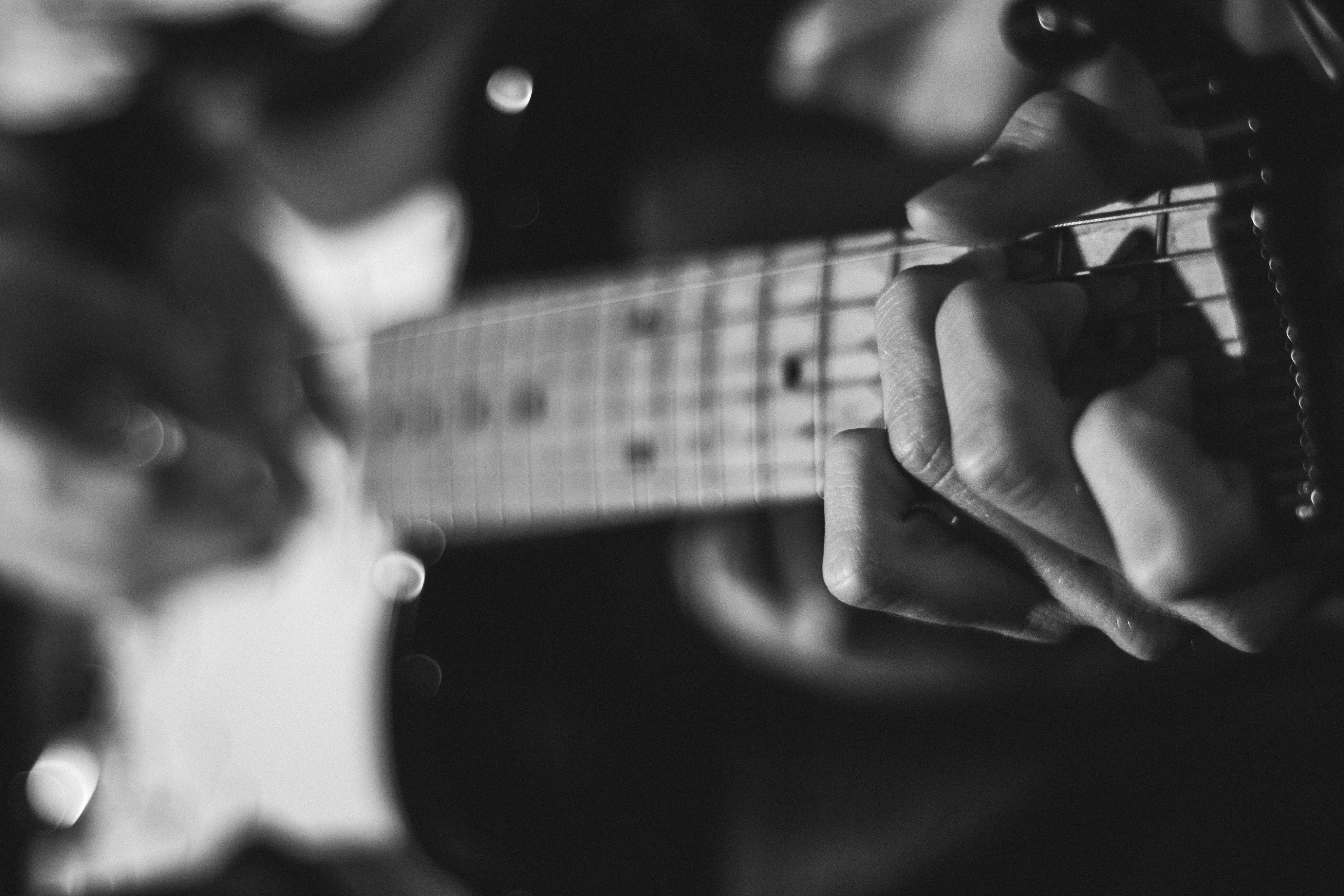Close-up of hands on electric guitar fretboard — focused targeted practice technique