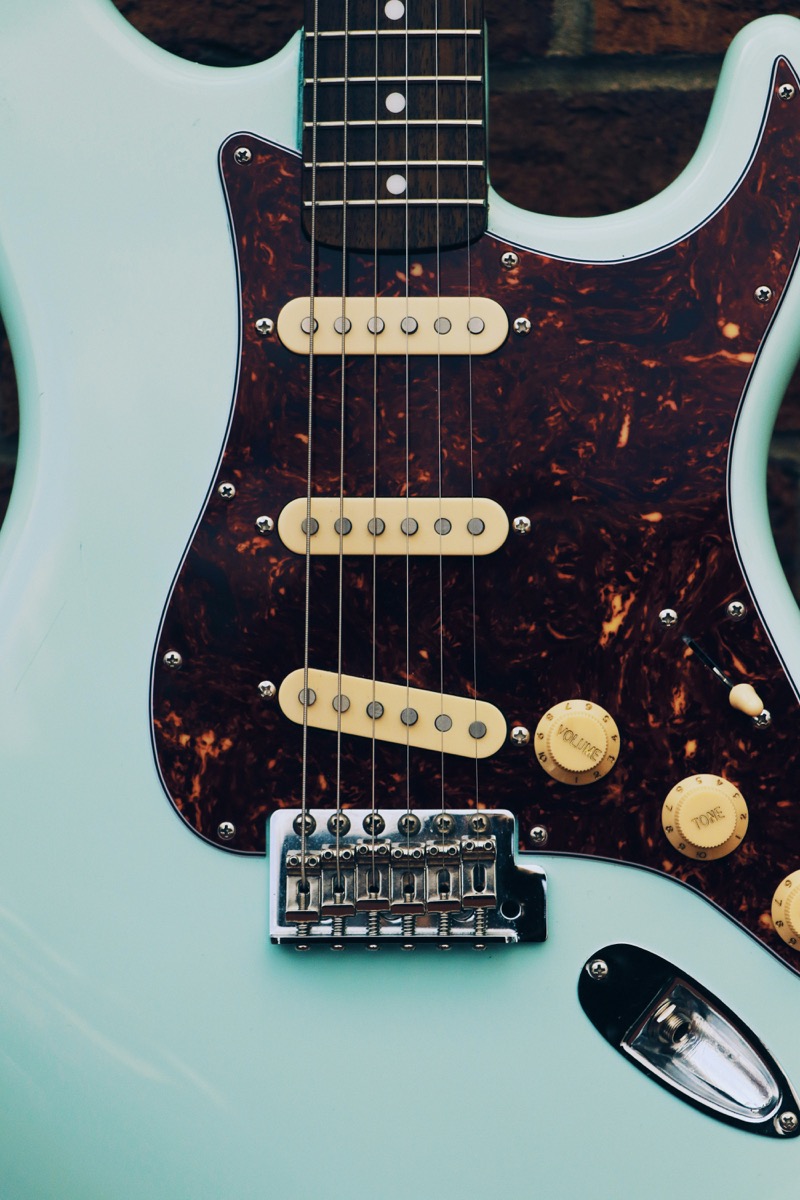 Boutique Telecaster-style guitar with wood grain body — handcrafted guitars that represent everything Fender's crackdown threatens