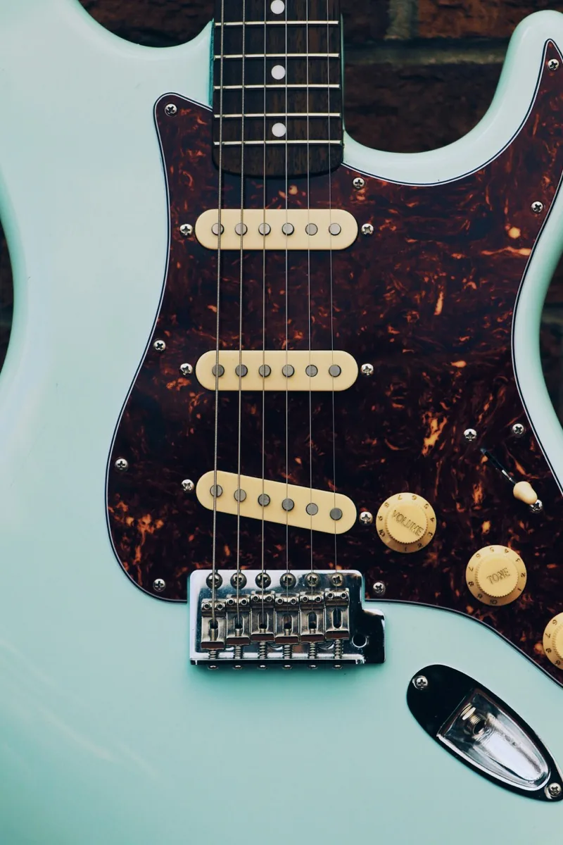 Boutique Telecaster-style guitar with wood grain body — handcrafted guitars that represent everything Fender's crackdown threatens