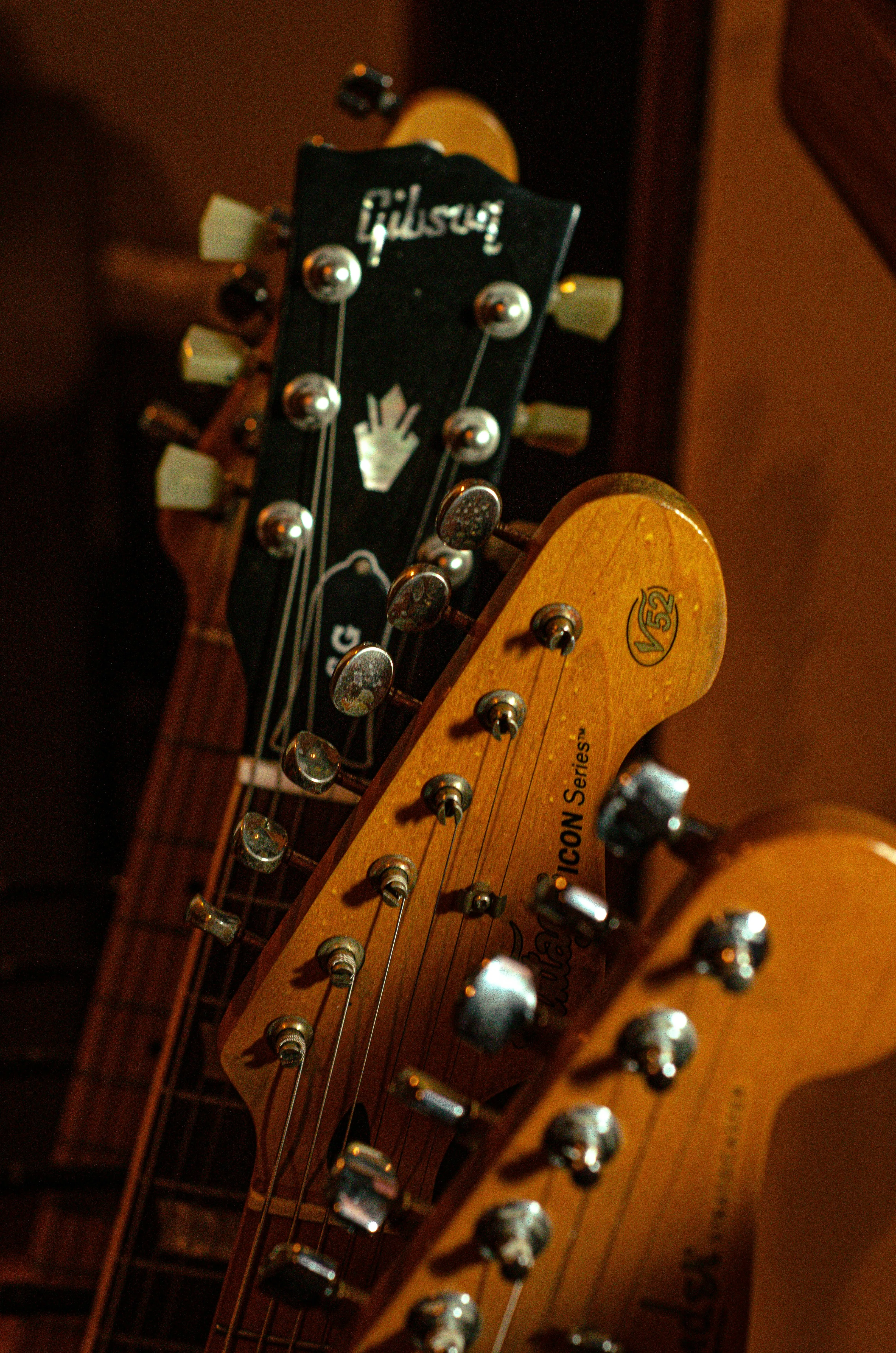 Gibson and Fender-style guitar headstocks side by side — the yin and yang of the electric guitar world