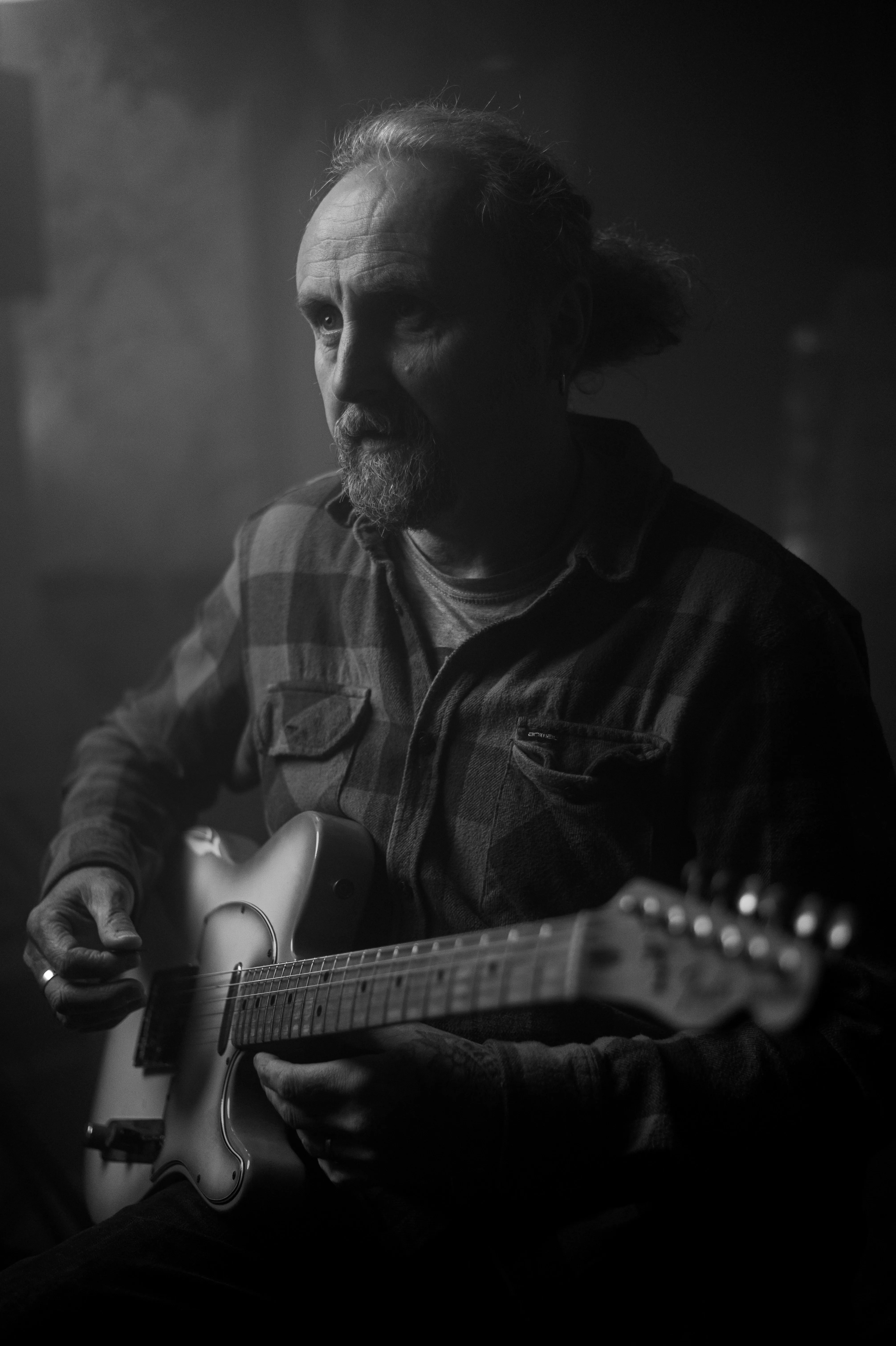 Adult guitarist in focused concentration with electric guitar — deliberate practice
