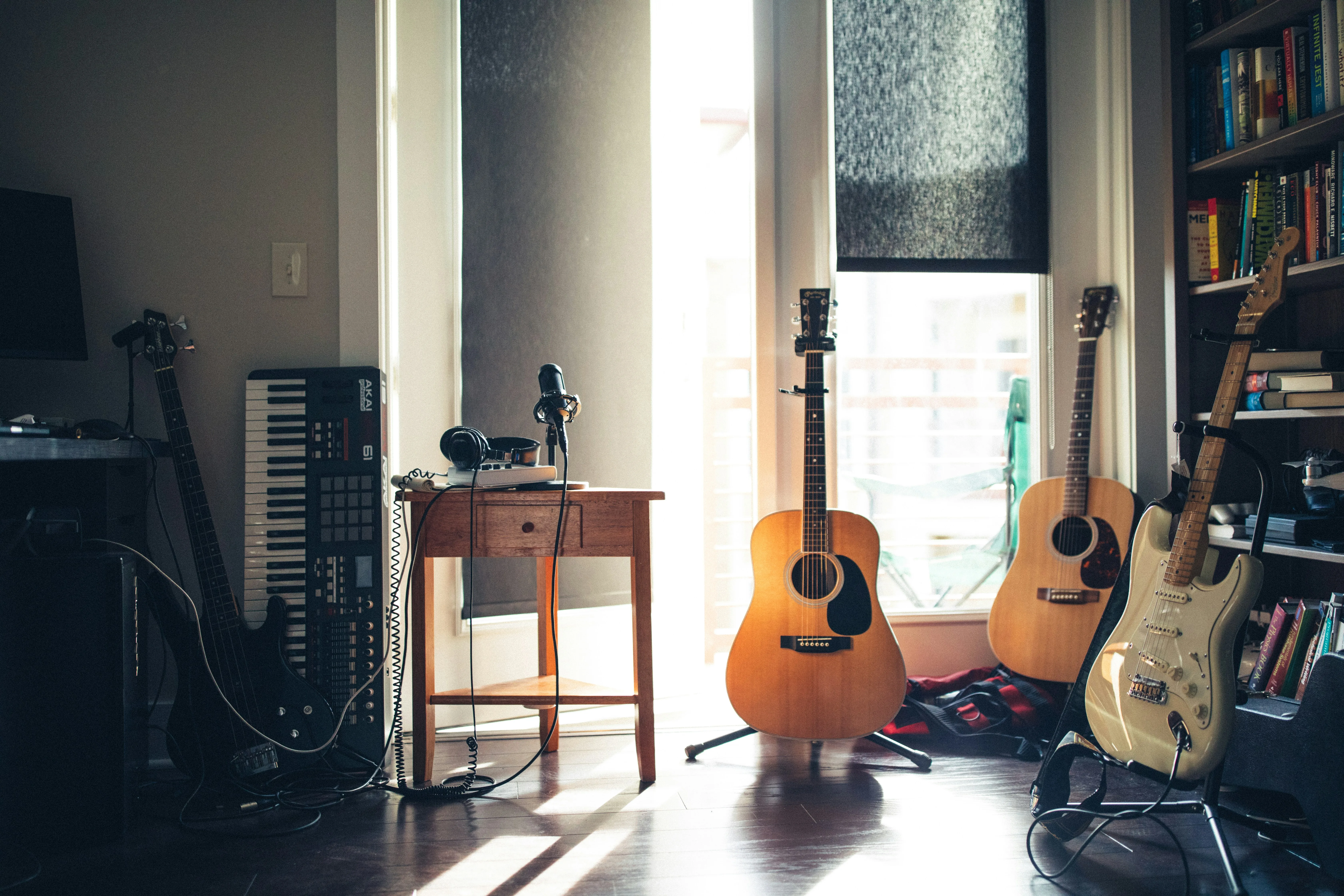 Home music room with acoustic guitars and keyboard — learning multiple instruments as an adult