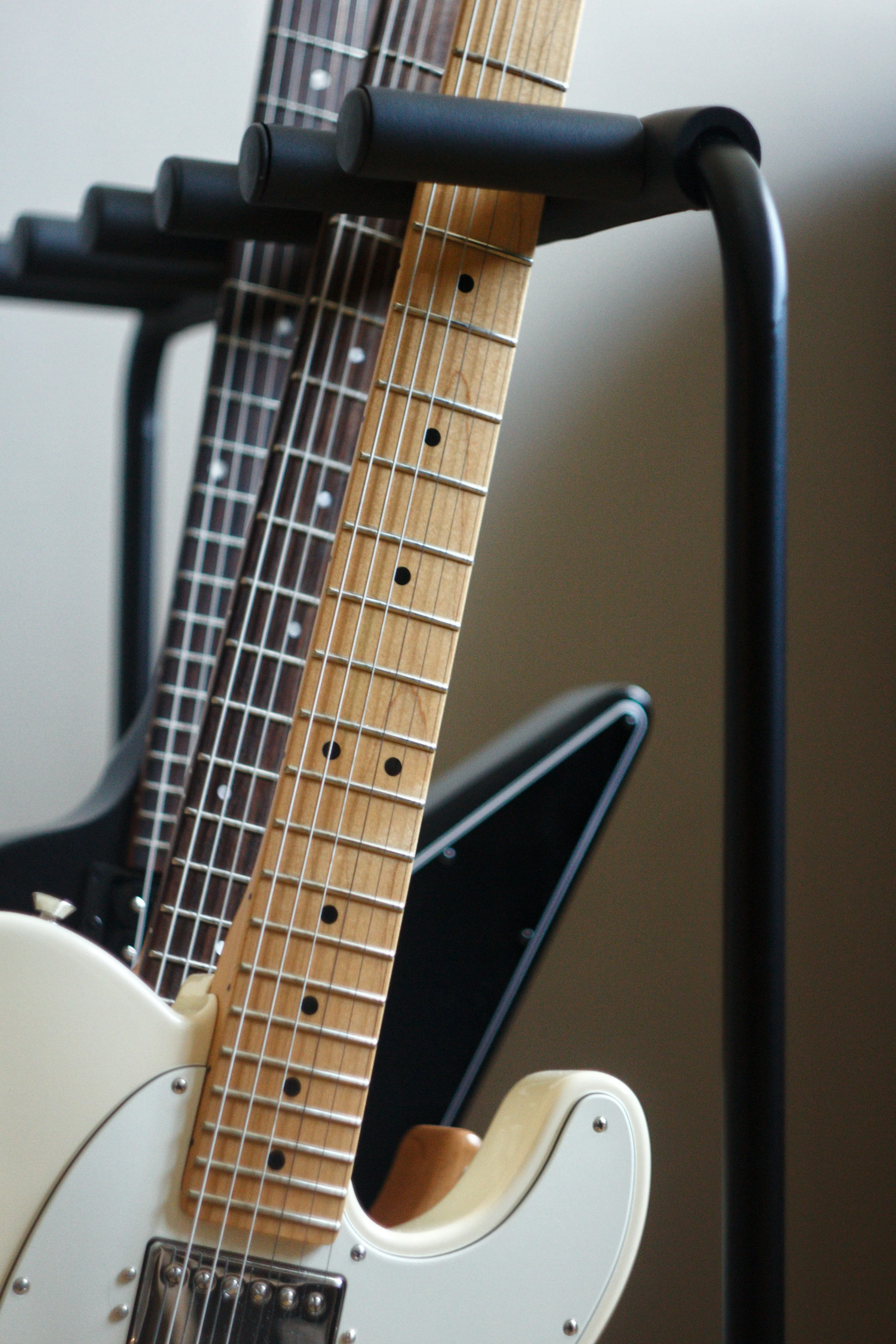 Close-up of guitar necks on a stand — the Telecaster body shape has nothing to do with Fender's Stratocaster legal campaign